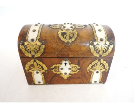 FIGURED WALNUT CASKET SHAPED TEA CADDY
with brass detail overlaid with ivory, the lift up lid revealing two lidded compartmen