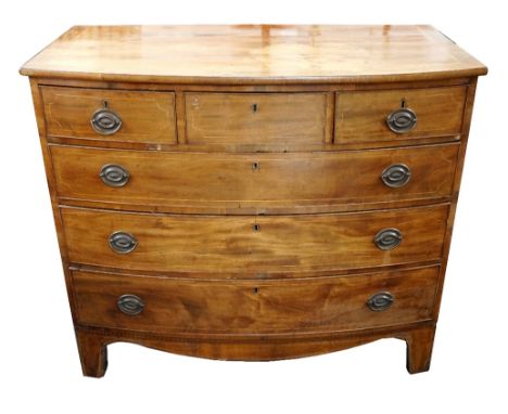 GEORGE III MAHOGANY BOW FRONT CHEST OF DRAWERS
with three short and three long graduated and cockbeaded drawers, standing on 