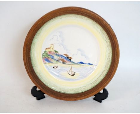 CLARICE CLIFF CRAYON SCENE WALL PLATE
by Rene Dale circa 1934, a coastal image with buildings and boats, printed and impresse