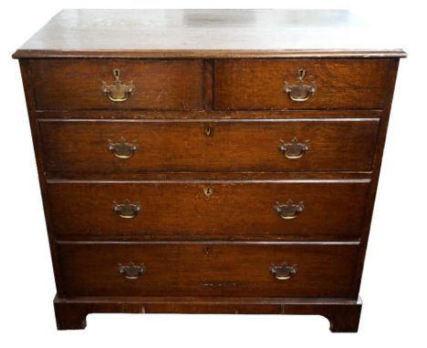 OAK CHEST OF DRAWERS
the moulded top above two short and three long graduated drawers, standing on bracket feet, 97cm wide 