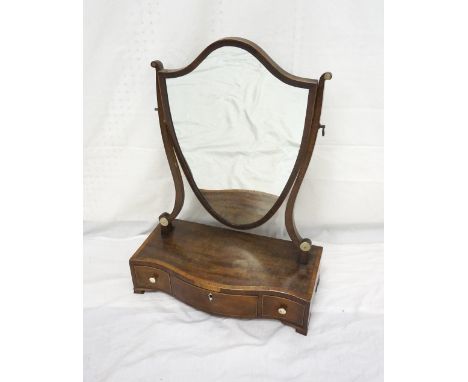 GEORGE III MAHOGANY SWING TOILET MIRROR
with a shield shape mirror supported by shaped arms above a serpentine base with thre