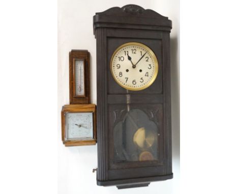 1920's OAK CASED WALL CLOCK
with key and pendulum, 78cm high; and an oak cased wall barometer, 44cm high (2)