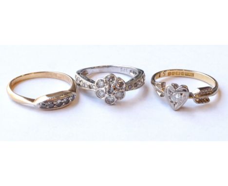 THREE DIAMOND SET RINGS
comprising a five stone example in eighteen carat gold, one with heart and arrow setting also in eigh