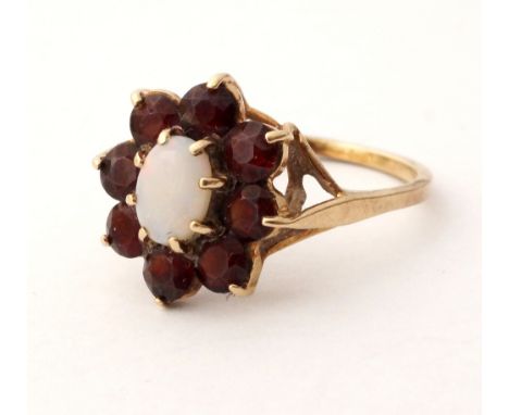 GARNET AND OPAL CLUSTER DRESS RING
the central opal in eight garnet surround, on nine carat gold shank, ring size M-N