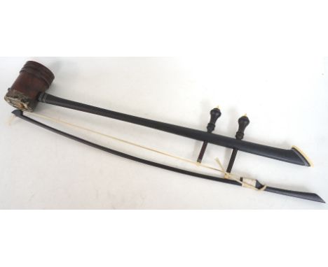 CHINESE ERHU
with a long shaped hardwood stick body with two tuning pegs above a turned resonator box with snake skin to one 