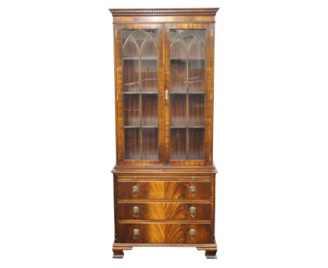 GEORGIAN STYLE MAHOGANY BOOKCASE 
the moulded dentil cornice above a pair of glazed beaded doors with shelved interior, above