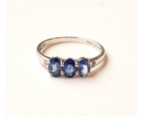 SAPPHIRE AND DIAMOND RING
the three central oval cut sapphires flanked by a diamond to each shoulder, on nine carat white gol