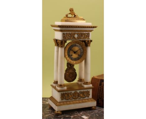 A French Empire gilt bronze mounted alabaster portico clock, 9cm silvered chapter ring inscribed with Roman numerals, twin-wi