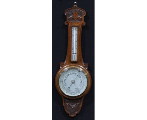 An Edwardian oak wheel barometer, the silvered register inscribed BENN FRANKS. OPTICIAN, HULL, HANLEY &amp; C, 80cm high, c.1