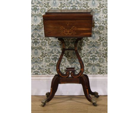 A Regency rosewood and marquetry teapoy, hinged cover enclosing tea canisters and provisions for spoons, lyre shaped support,