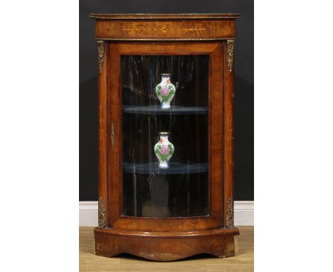 A Victorian Franglais gilt metal mounted walnut and marquetry bowfront corner vitrine, oversailing top above a glazed door en