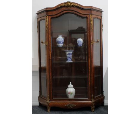 A large late 19th century French gilt metal mounted kingwood vitrine, in the Louis XV taste, chapeau de gendarme cresting abo