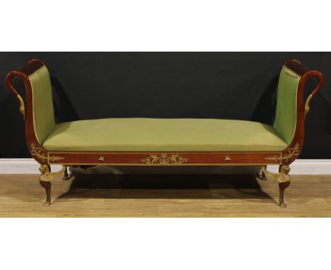 A 19th century Empire design gilt metal mounted mahogany Récamier sofa or daybed, the ends terminated in swan heads, stuffed-