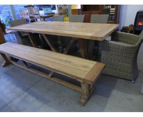 A Bramblecrest Kuta teak garden table measuring 240cm x 100cm with a matching bench, three Sahara side chairs and two Sahara 