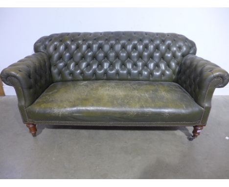 A 19th century leather button back sofa in green leather on turned legs
Condition report: Split to the seat