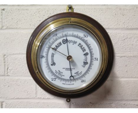 A brass marine style aneroid barometer by John Baker, London 
Condition report: Working  