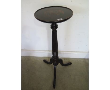 An ebonised tripod torchere - Height 85 cm 