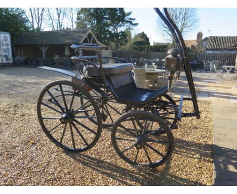 A vintage four wheel Horse drawn carriage, driving cart, pleasure vehicle with upholstered seats and carnage lights and leaf 
