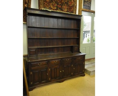 A good quality 20th century oak dresser with an open rack top above a four drawer four door base - Width 2.1 m x 2.27 cm x 51