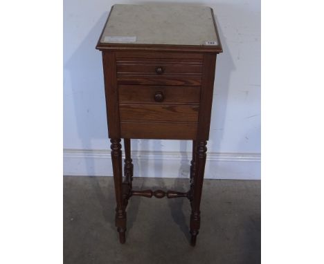 A 19th century French pitch pine bedside cabinet with marble top and marble interior shelf  with drop front on turned leg sup