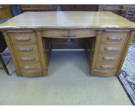 A good 20th century light oak kneehole desk with two slides and nine drawers and panelled sides and back - Height 83 cm x Wid