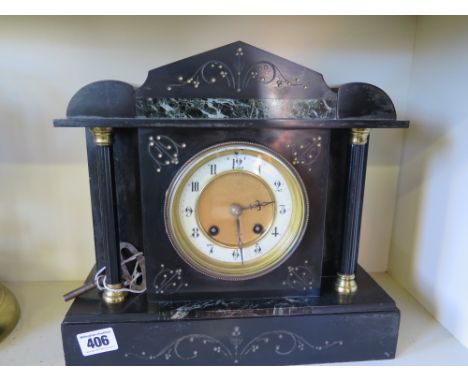 A slate mantle clock with enamel and gilded face with Arabic numerals, case with carved decoration and marble inlays, un name