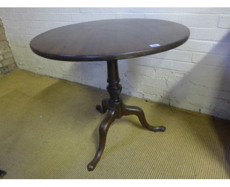 A mahogany tripod table on a wrythern turned base and one piece top