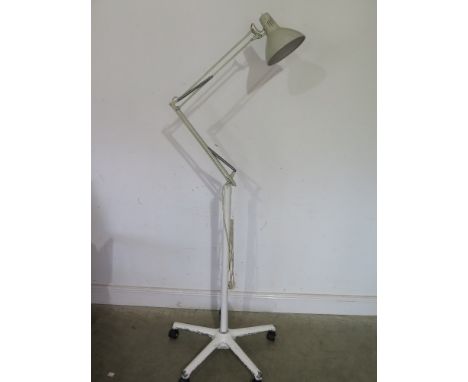 A steel angle poise style lamp mounted on a cast aluminium five splay base maximum height approx 200cm
