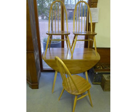 An Ercol golden elm drop leaf dining table and three chairs - 1.13 m x 1.23 m