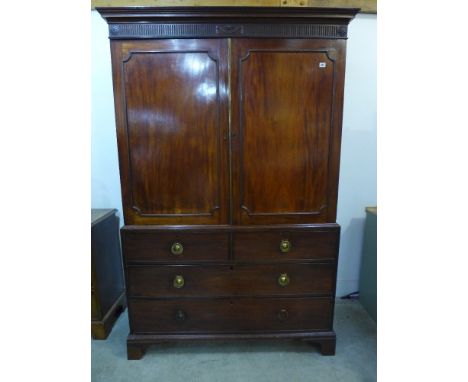 A Georgian mahogany linen press - the four drawer base, two short over two long over bracket feet, press top with panelled do
