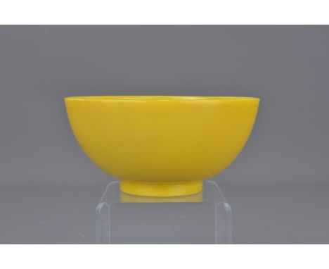 A Chinese 18th century yellow Peking glass bowl incised with  four character mark of Qinglong and of the period. Area of repa