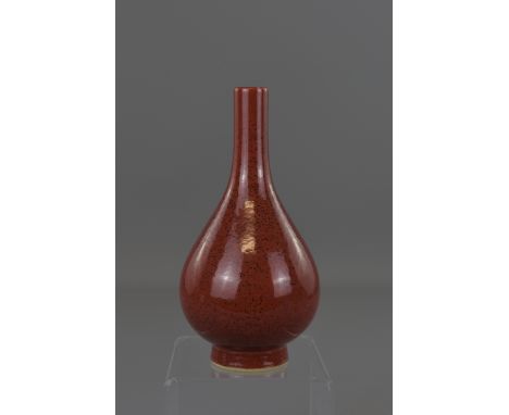 A Chinese 18/19th century liver-red porcelain Guanyin vase with six character mark of Kangxi. 18 cm tall.