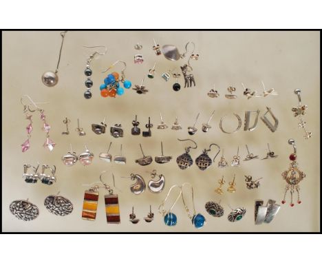 A selection of silver earrings including stud and drop earrings to include a pair of celtic knot earrings, a pair of turquois