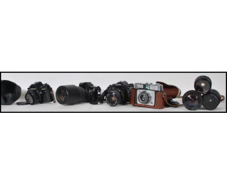 A collection various cameras and lenses to include makes and models form Canon EOS 500 with a Sigma Autofocus lens, Vivitar v