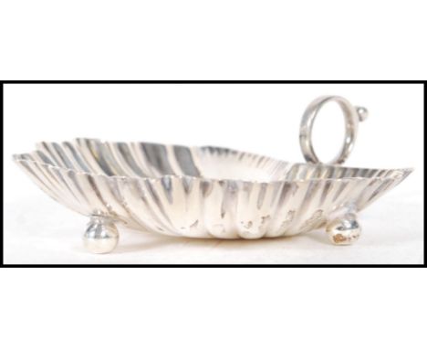 A 20th Century Mappin and Webb silver hallmarked trinket dish in the form of a leaf with shaped details having a loop handle 