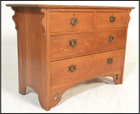 A late Victorian 19th century Arts &amp; Crafts oak chest of drawers. Raised on bracket feet with a bank of drawers having go