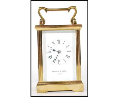 A 20th Century brass carriage clock by Mappin and Webb having a white enamelled face with roman numerals to the chaptering ri