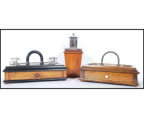 Two early 20th Century wooden desk top tidies / pen holders to include an oak tidy having two pen and inkwell recesses with a