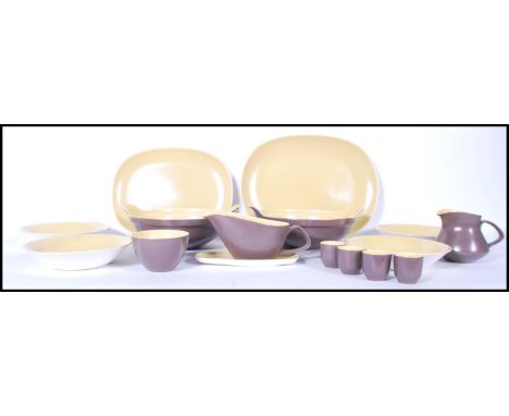 A vintage 20th Century part dinner service by Poole Pottery. The two tone colour service consisting of platters, tureens, sau