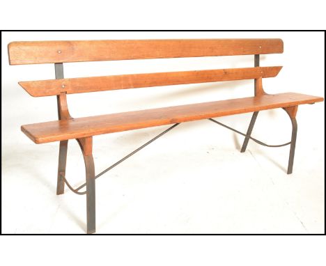 A 20th Century Victorian style pine station bench, raised on upright metal supports with plank seat pad and backrest.&nbsp;Me