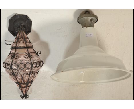 Two mid 20th Century vintage retro pendant ceiling lights to include a shaped amethyst murano style glass porch lantern havin