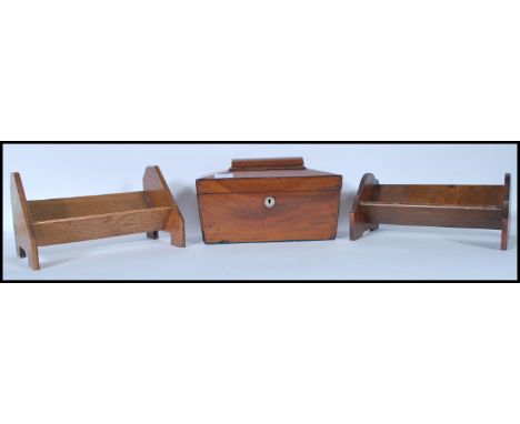 A 19th Century Georgian mahogany tea caddy of sarcophagus form having a mother of pearl escutcheon to the front together with