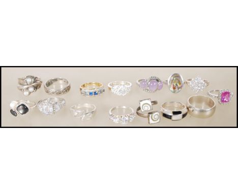 A collection of stamped 925 silver rings to include an mother of pearl ring, a celtic knot ring, a dress ring set with a larg