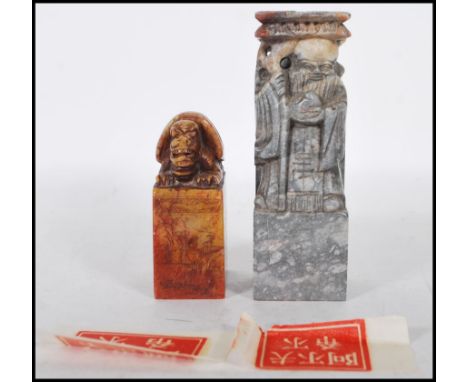 Two 20th Century Chinese carved soapstone cylinder desk seals of rectangular form, one carved into the form of an immortal wi