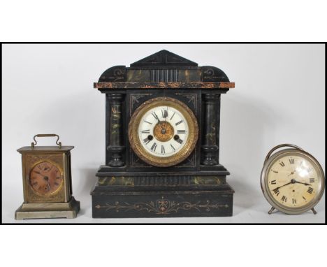 A collection of three clocks to include a late 19th Century Victorian Hamburg and America eight day mantel clock of architect