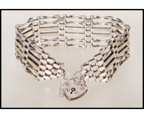 A hallmarked 925 6 bar gate link bracelet having a heart lock clasp. Hallmarked London. Weight 19.9g.
