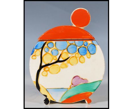 A early 20th Century Art Deco ceramic lidded sugar dish, hand painted with cottages to one side hills and trees to the other,