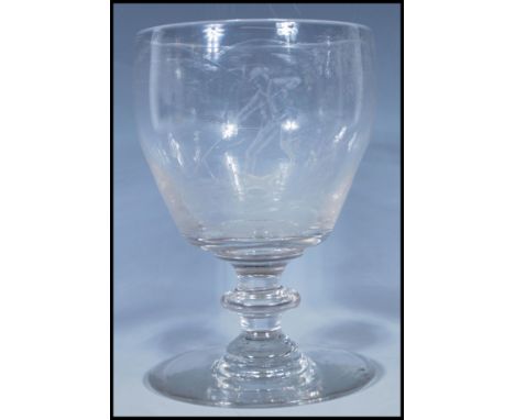 Hunting interest- An 18th/ early 19th Century Georgian glass goblet having finely engraved hunting scenes depicting hare cour