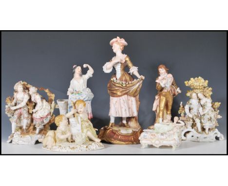 A collection of 20th Century German ceramic figurines to include two Sitzendorf figure groups depicting characters with oak t