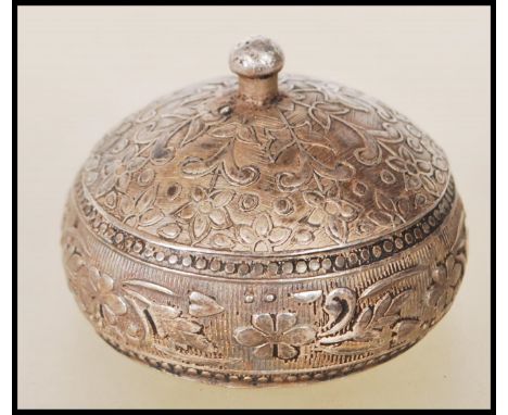 A mid 20th Century silver 925 lidded trinket pot. The body having embossed floral and pattern decoration with gadrooned borde